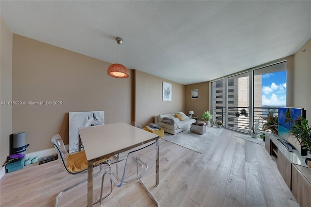 335 S Biscayne Blvd Unit 3110, Miami, FL 33131 - living area with light wood-type flooring, expansive windows, and a textured ceiling