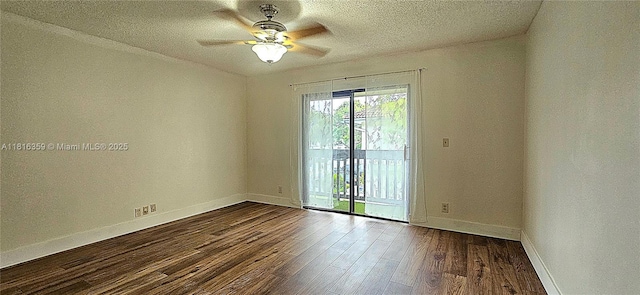 spare room featuring baseboards, dark wood-style flooring, a ceiling fan, and a textured ceiling