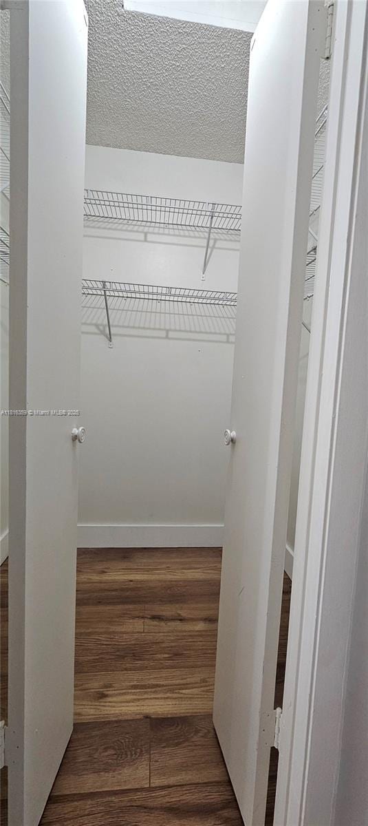 spacious closet with wood finished floors