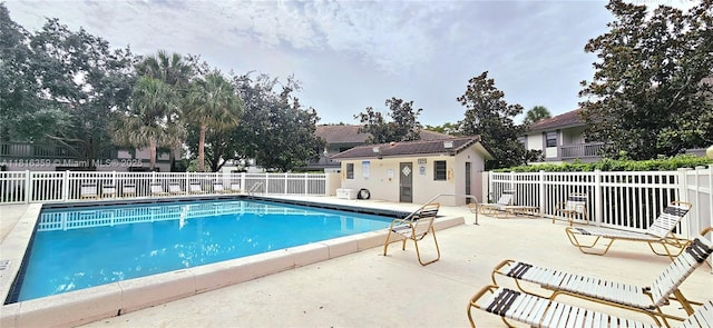 community pool with a patio area