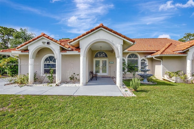 17084 N 33rd Rd N, Loxahatchee, FL 33470 - entrance to property featuring french doors, a yard, stucco siding, and a tiled roof