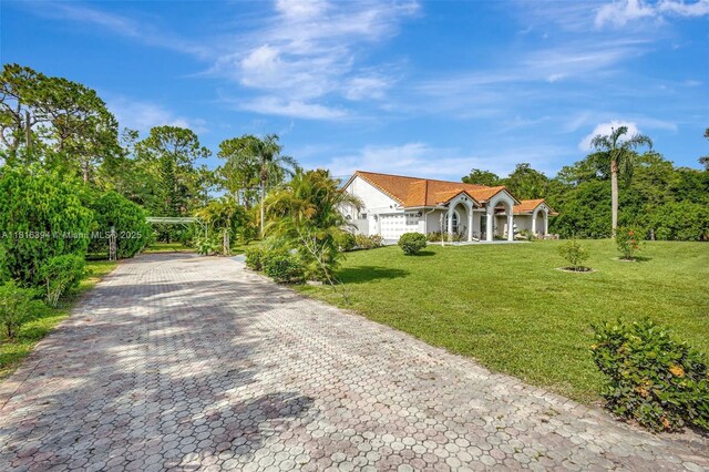 17084 N 33rd Rd N, Loxahatchee, FL 33470 - view of front of property featuring a front yard, decorative driveway, and a carport