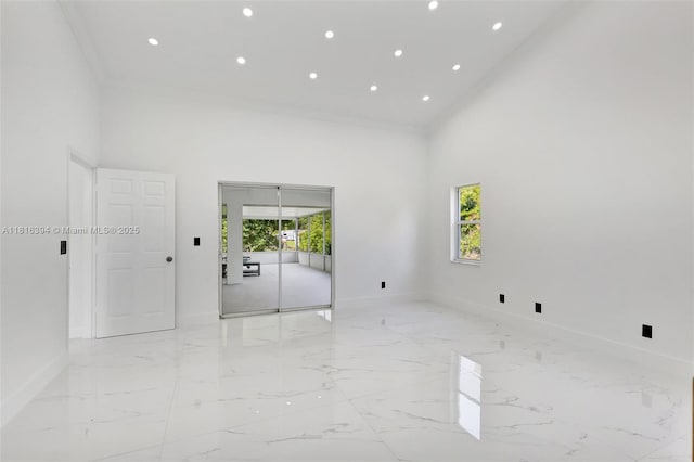 17084 N 33rd Rd N, Loxahatchee, FL 33470 - empty room featuring light marble finish flooring, baseboards, a high ceiling, and recessed lighting