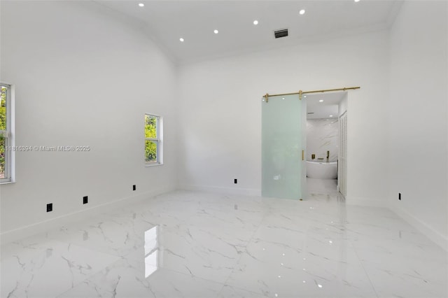 17084 N 33rd Rd N, Loxahatchee, FL 33470 - empty room featuring a towering ceiling, baseboards, marble finish flooring, and recessed lighting