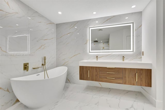 17084 N 33rd Rd N, Loxahatchee, FL 33470 - full bath with double vanity, marble tiled floors, a freestanding tub, recessed lighting, and stone wall