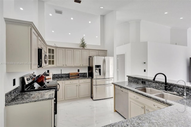 17084 N 33rd Rd N, Loxahatchee, FL 33470 - kitchen featuring stainless steel appliances, a high ceiling, a sink, dark stone countertops, and light marble finish flooring