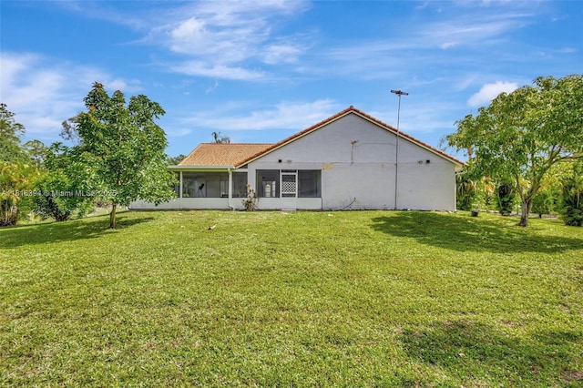 17084 N 33rd Rd N, Loxahatchee, FL 33470 - back of house featuring a sunroom and a lawn