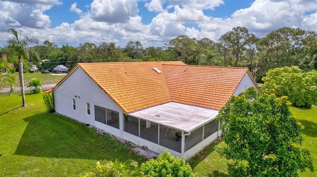 17084 N 33rd Rd N, Loxahatchee, FL 33470 - back of house featuring a sunroom, a tile roof, a yard, and stucco siding