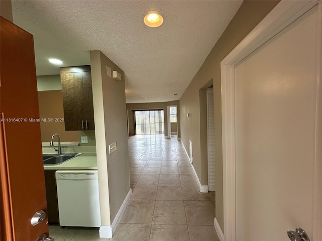 2541 NW 56th Ave Unit 3-19, Lauderhill, FL 33313 - hall with a sink, a textured ceiling, light tile patterned flooring, and baseboards