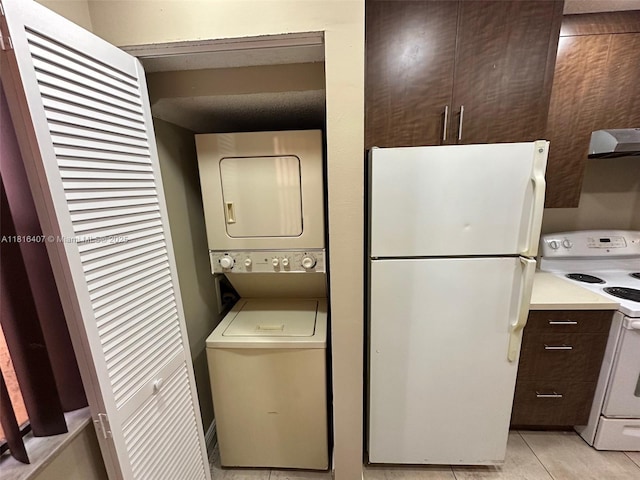 2541 NW 56th Ave Unit 3-19, Lauderhill, FL 33313 - washroom featuring stacked washing machine and dryer and light tile patterned floors