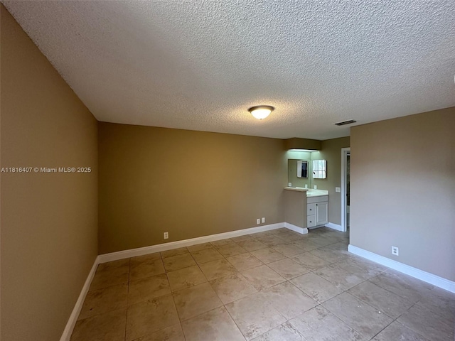 2541 NW 56th Ave Unit 3-19, Lauderhill, FL 33313 - unfurnished room with a textured ceiling, light tile patterned flooring, and baseboards
