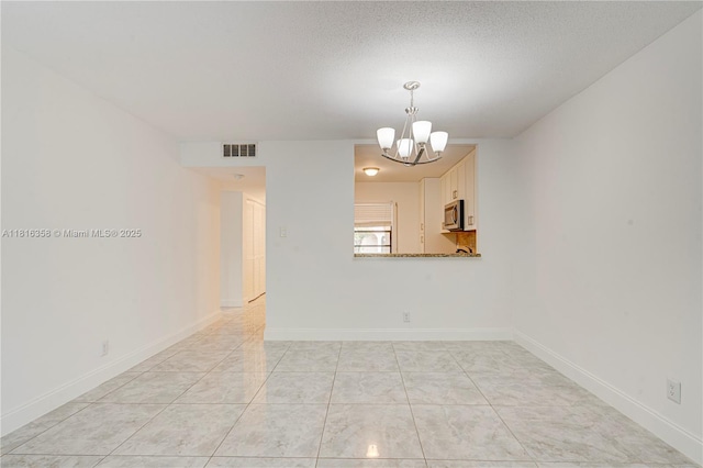136 S Cypress Rd Unit 323, Pompano Beach, FL 33060 - empty room with a chandelier and baseboards