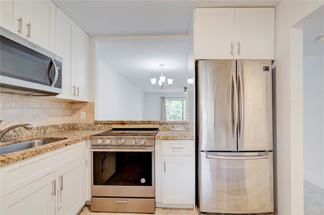 136 S Cypress Rd Unit 323, Pompano Beach, FL 33060 - kitchen with appliances with stainless steel finishes, a sink, light stone counters, and white cabinetry