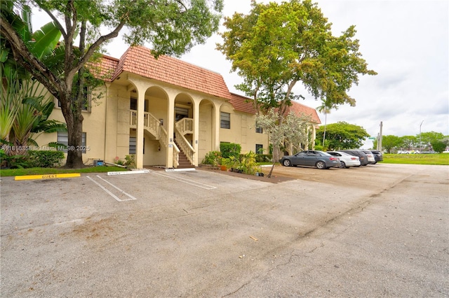136 S Cypress Rd Unit 323, Pompano Beach, FL 33060 - view of property with uncovered parking and stairway