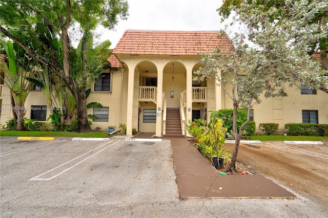 136 S Cypress Rd Unit 323, Pompano Beach, FL 33060 - view of property featuring stairs and uncovered parking