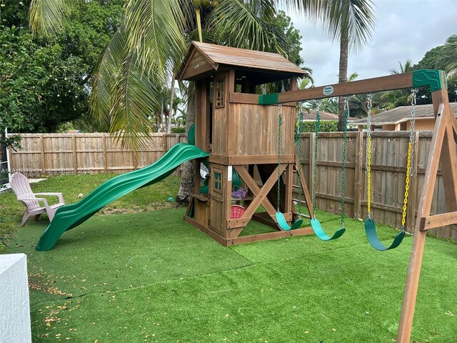 17630 NE 4th Ave, North Miami Beach, FL 33162 - view of front of home with a garage, concrete driveway, stucco siding, and french doors