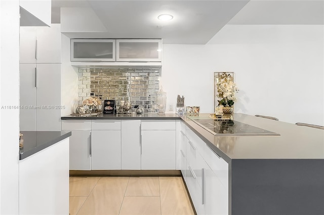 1800 S Ocean Dr Unit 2208, Hallandale Beach, FL 33009 - bar with black electric stovetop, light tile patterned flooring, and backsplash