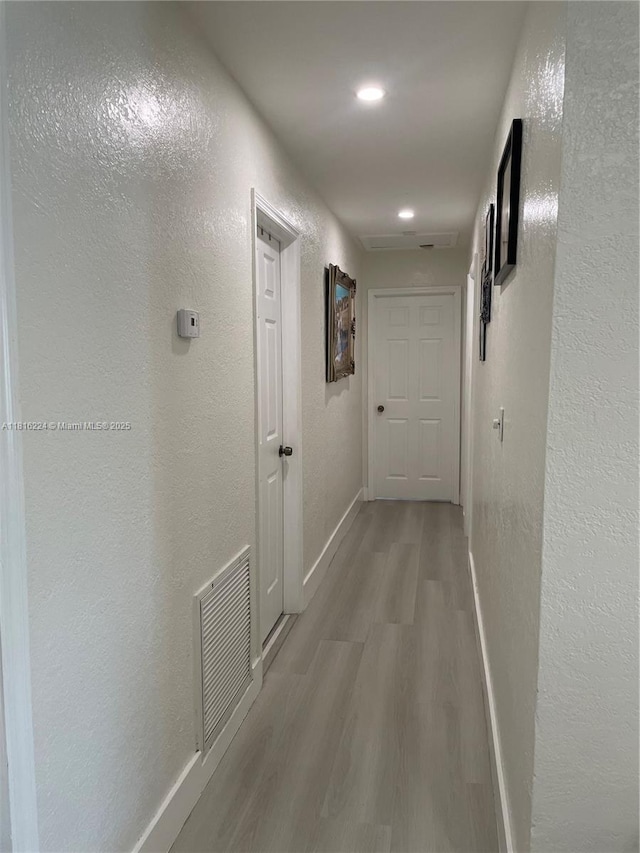 14511 SW 294th St, Homestead, FL 33033 - hallway with baseboards, light wood-style flooring, a textured wall, and recessed lighting