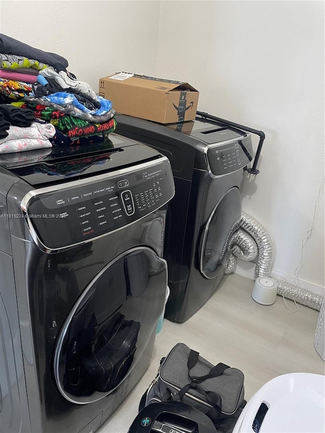 14511 SW 294th St, Homestead, FL 33033 - laundry area featuring washing machine and dryer and wood finished floors