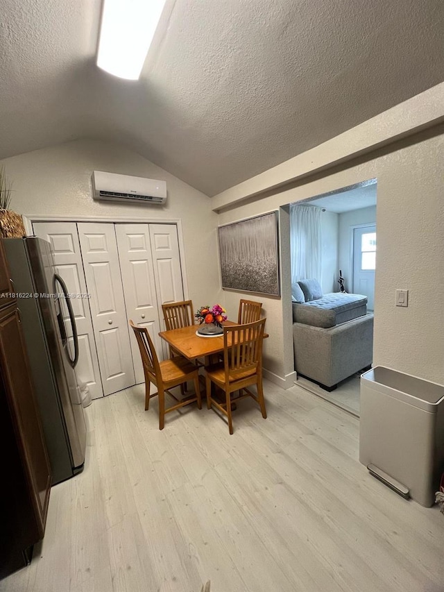 14511 SW 294th St, Homestead, FL 33033 - dining space featuring light wood-style floors, a textured ceiling, an AC wall unit, and vaulted ceiling