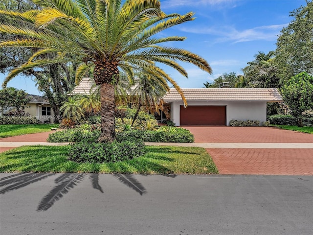 3121 N 52nd Ave, Hollywood, FL 33021 - view of front of property with a tile roof, stucco siding, decorative driveway, and a garage