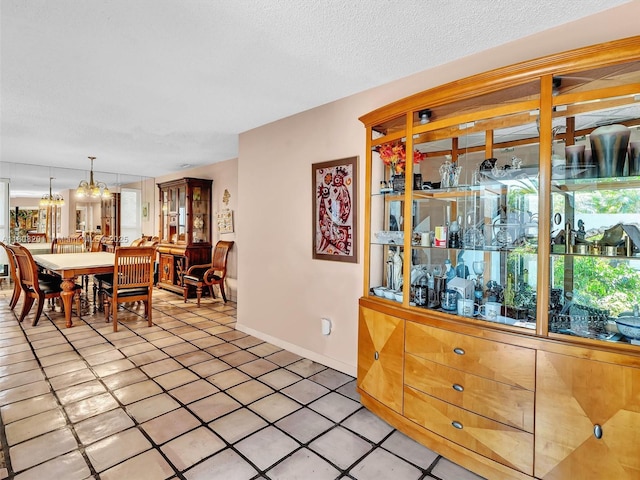 3121 N 52nd Ave, Hollywood, FL 33021 - dining space featuring a chandelier, light tile patterned flooring, and baseboards