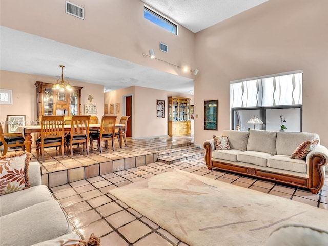 3121 N 52nd Ave, Hollywood, FL 33021 - tiled living area featuring a towering ceiling and a chandelier