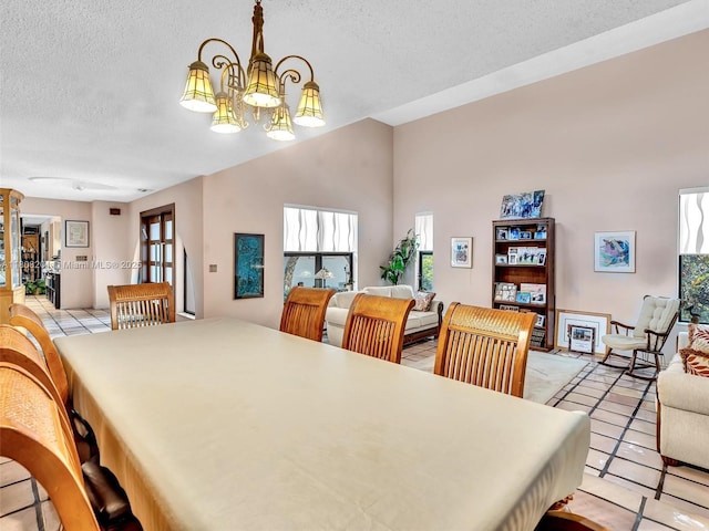 3121 N 52nd Ave, Hollywood, FL 33021 - dining room with a textured ceiling, light tile patterned floors, a chandelier, and healthy amount of natural light