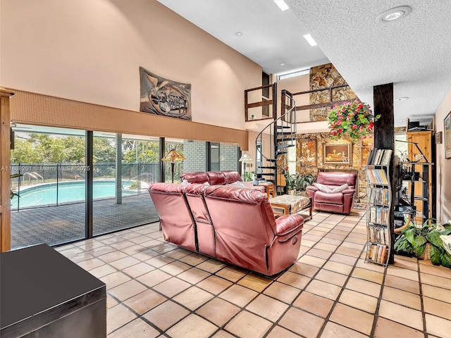 3121 N 52nd Ave, Hollywood, FL 33021 - living area featuring light tile patterned floors, a textured ceiling, a towering ceiling, and stairs