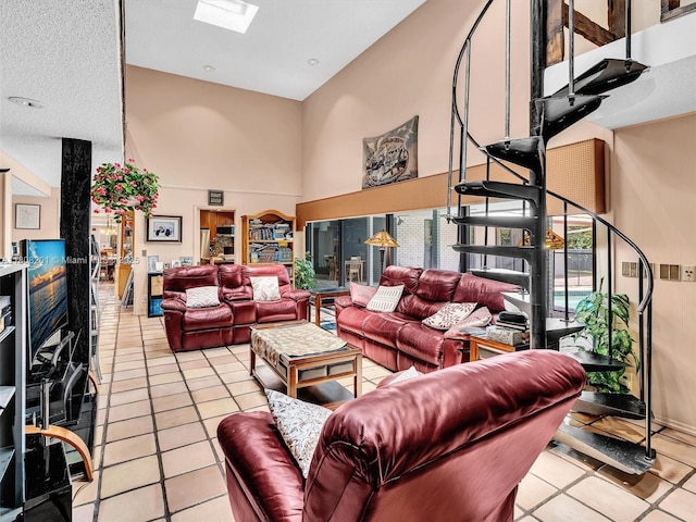 3121 N 52nd Ave, Hollywood, FL 33021 - living area with light tile patterned floors, a skylight, and a high ceiling