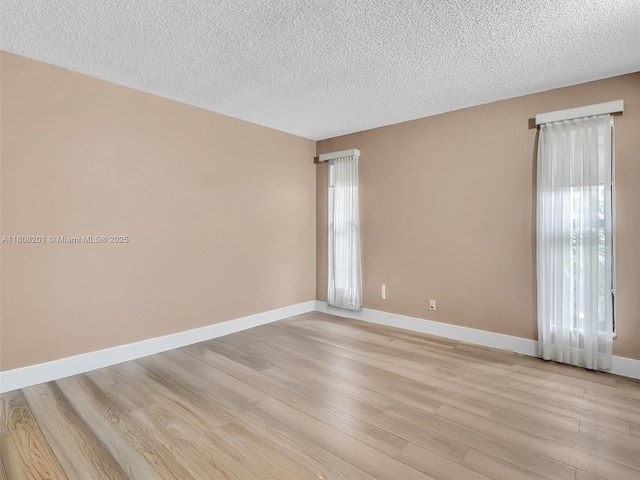 3121 N 52nd Ave, Hollywood, FL 33021 - unfurnished room featuring light wood-type flooring, a textured ceiling, and baseboards