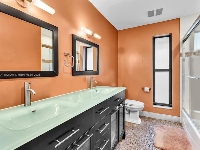 3121 N 52nd Ave, Hollywood, FL 33021 - bathroom featuring toilet, baseboards, and double vanity