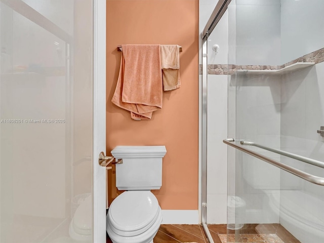 3121 N 52nd Ave, Hollywood, FL 33021 - bathroom featuring toilet, a shower stall, and baseboards