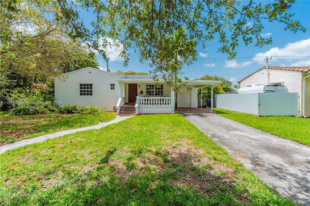 1110 Falcon Ave, Miami Springs, FL 33166 - ranch-style house featuring driveway, a carport, a porch, and stucco siding