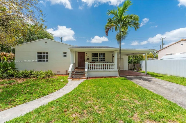 1110 Falcon Ave, Miami Springs, FL 33166 - view of front of house with asphalt driveway, a porch, a carport, and stucco siding