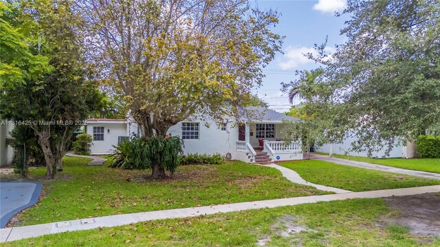 1110 Falcon Ave, Miami Springs, FL 33166 - view of front facade featuring a front lawn and covered porch