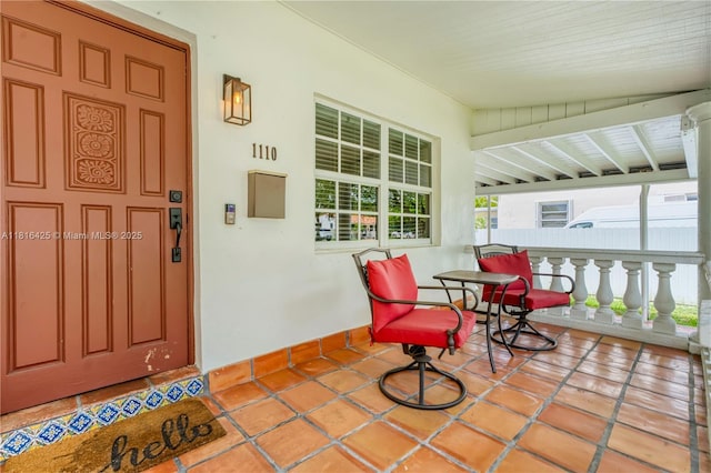 1110 Falcon Ave, Miami Springs, FL 33166 - doorway to property with covered porch and stucco siding
