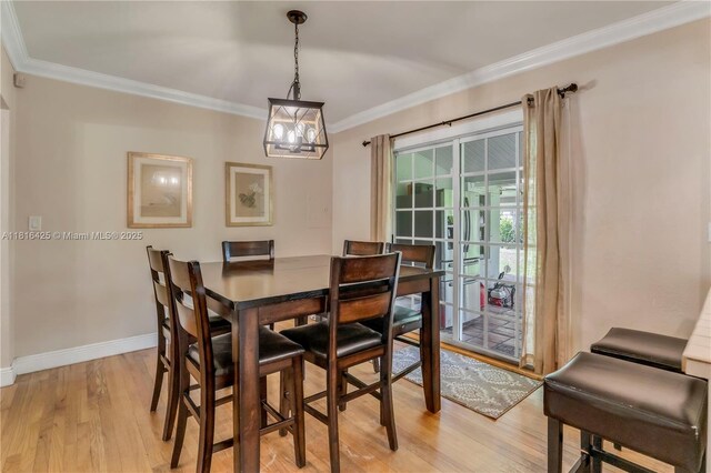 1110 Falcon Ave, Miami Springs, FL 33166 - dining space with crown molding, light wood-style floors, baseboards, and a chandelier