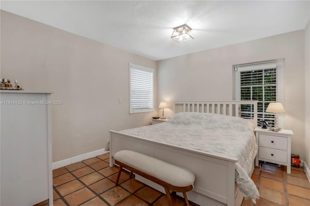1110 Falcon Ave, Miami Springs, FL 33166 - bedroom with light tile patterned floors and baseboards