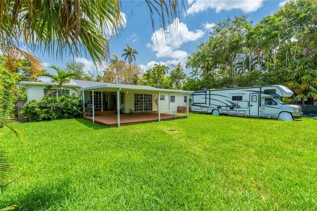 1110 Falcon Ave, Miami Springs, FL 33166 - back of property featuring a patio area and a lawn