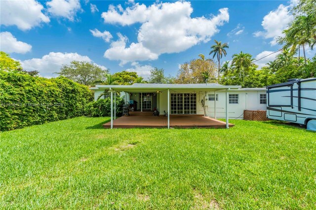 1110 Falcon Ave, Miami Springs, FL 33166 - rear view of property featuring a patio area and a yard