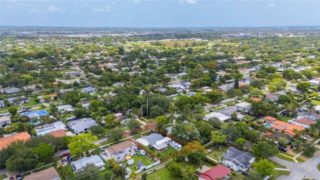 1110 Falcon Ave, Miami Springs, FL 33166 - aerial view of property and surrounding area featuring property boundaries highlighted and nearby suburban area