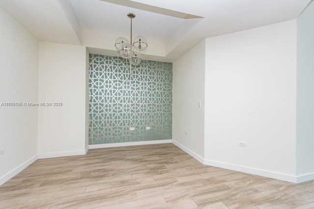 999 1st Ave Unit 2707, Miami, FL 33130 - unfurnished room featuring a chandelier, baseboards, and wood finished floors