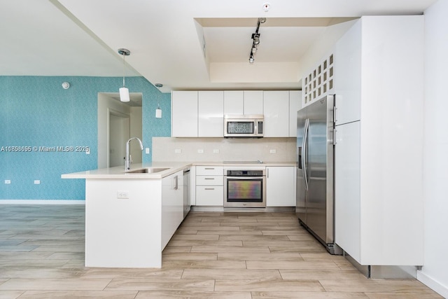 999 1st Ave Unit 2707, Miami, FL 33130 - kitchen with appliances with stainless steel finishes, a sink, a peninsula, rail lighting, and white cabinets