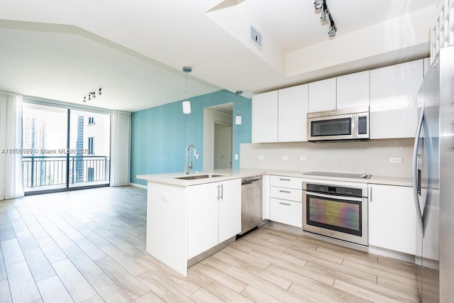 999 1st Ave Unit 2707, Miami, FL 33130 - kitchen featuring stainless steel appliances, a sink, a peninsula, and light countertops