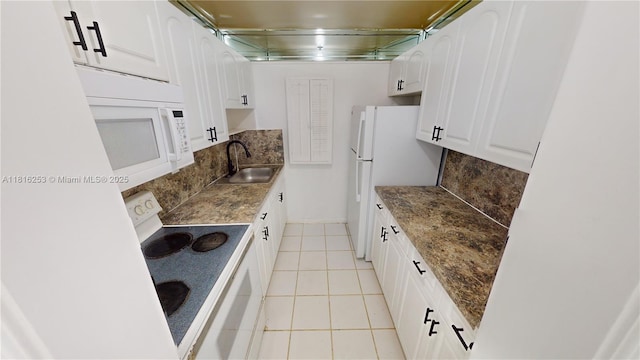 677 SW 9th Ave Unit 309, Miami, FL 33130 - kitchen with a sink, white appliances, backsplash, white cabinetry, and light tile patterned floors