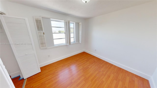 677 SW 9th Ave Unit 309, Miami, FL 33130 - unfurnished bedroom featuring a closet, light wood-type flooring, and baseboards