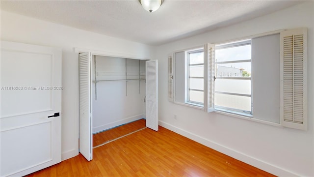 677 SW 9th Ave Unit 309, Miami, FL 33130 - unfurnished bedroom with a closet, light wood-type flooring, and baseboards