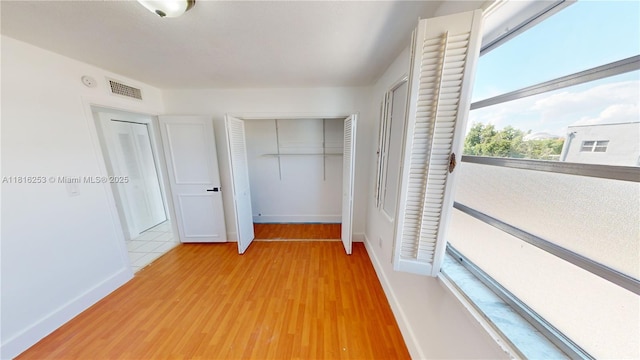 677 SW 9th Ave Unit 309, Miami, FL 33130 - unfurnished bedroom with a closet, baseboards, and light wood-style flooring