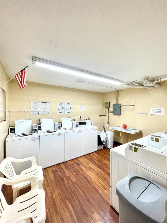 677 SW 9th Ave Unit 309, Miami, FL 33130 - shared laundry room featuring wood finished floors, washing machine and dryer, and electric panel